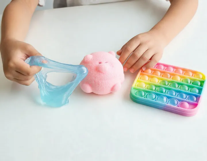 Child comparing slime stretch and squishy rebound